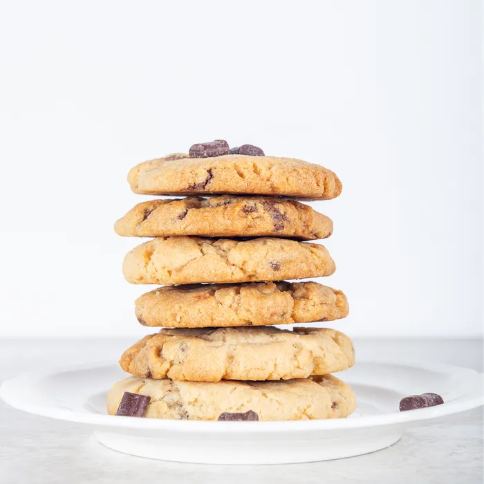 Stack of chocolate chip cookies on a white plate